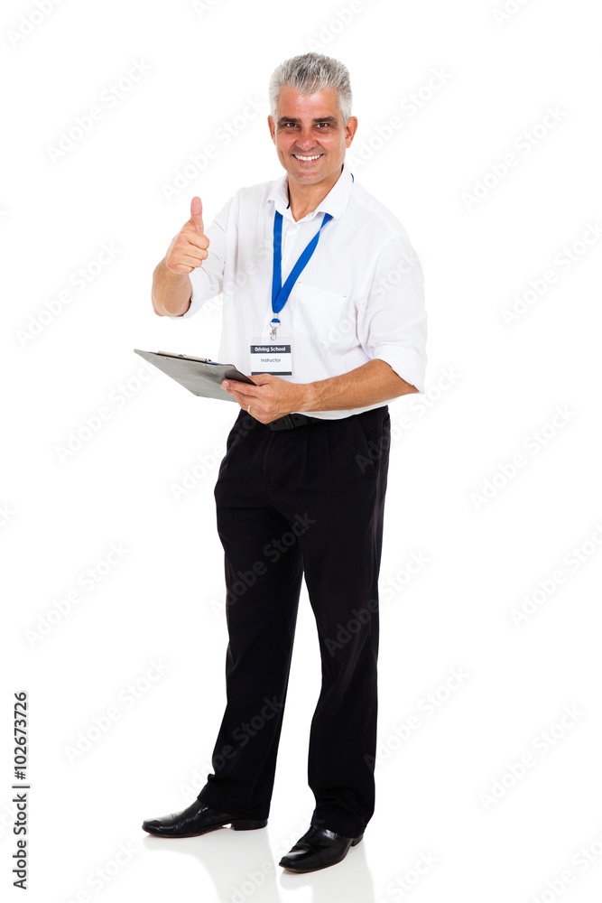 mid age driving instructor giving thumb up mid age driving instructor giving thumb up