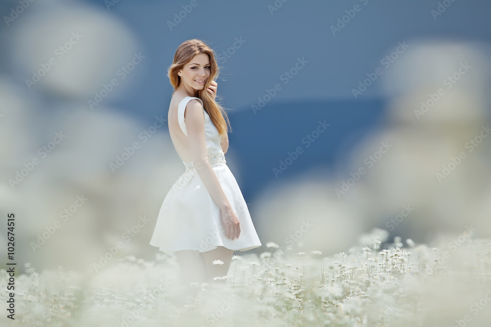 Beautiful young woman in a camomile field Beautiful young woman in a camomile field