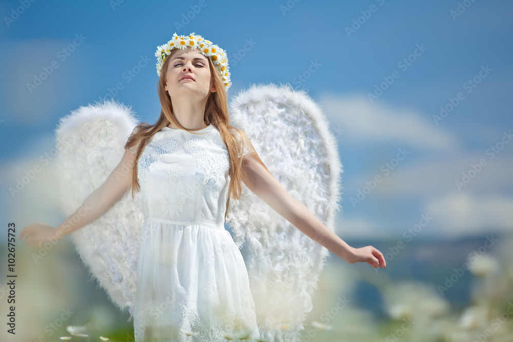 woman with wings in a camomile field woman with wings in a camomile field