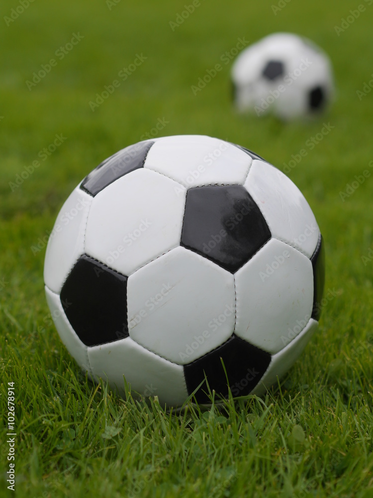 Soccer ball on green field