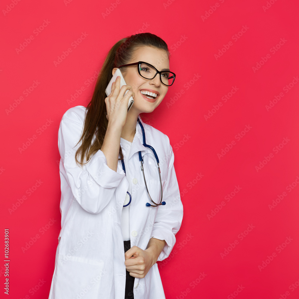 Amused Female Doctor On A Phone Amused Female Doctor On A Phone