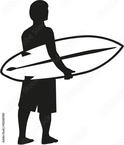 Surfer holding his surfboard and looking at the sea