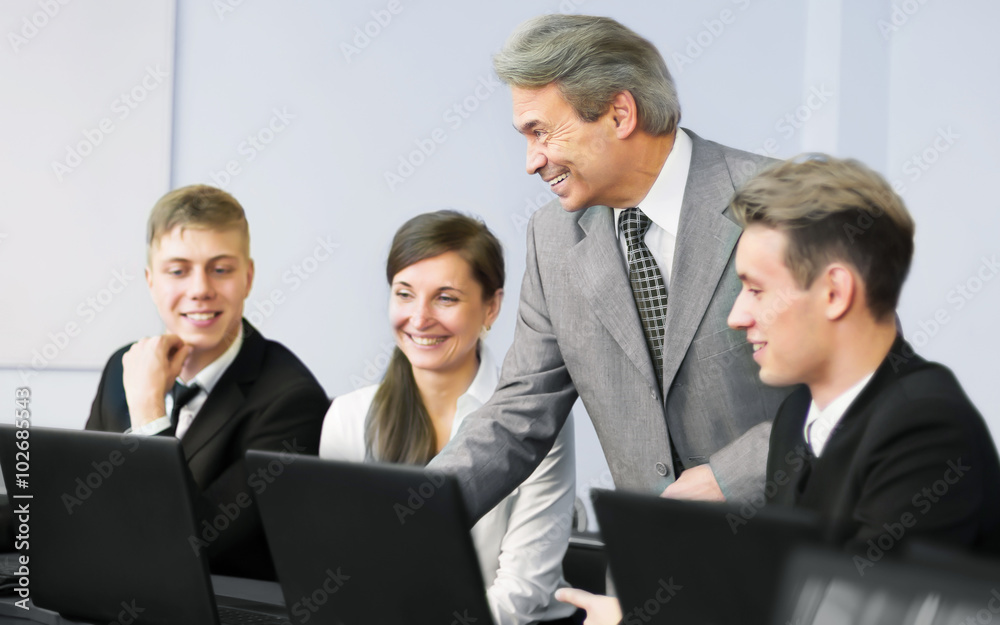 Business team working together on laptop in the office Business team working together on laptop in the office
