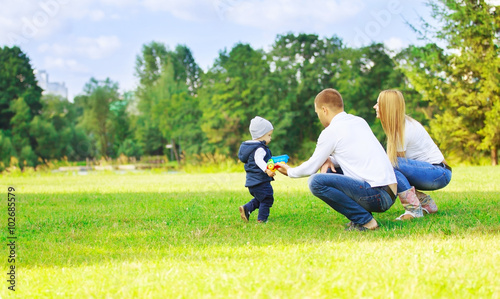 happy mom dad and son on a walk on a Sunny day