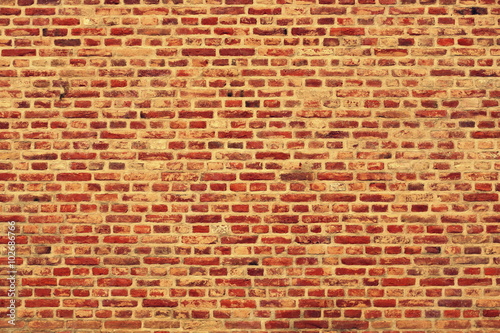 Brick wall horizontal background with red, orange and brown bricks - orange version