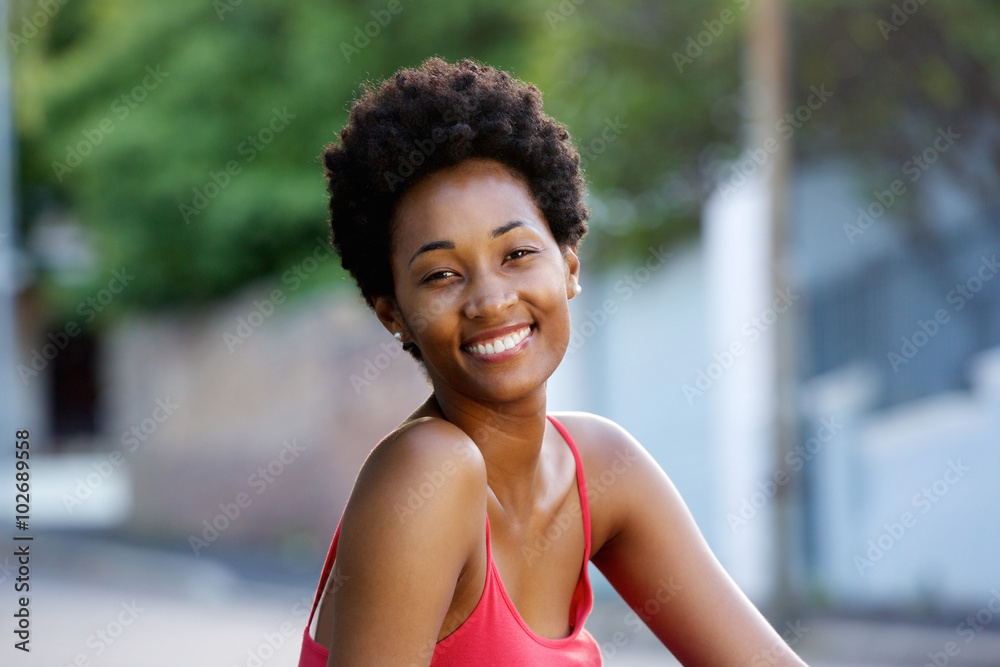 Happy young woman sitting outdoors Happy young woman sitting outdoors