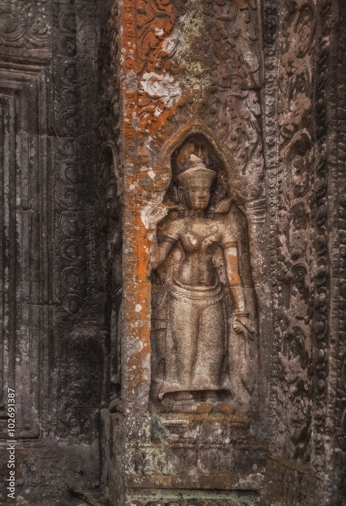 SIEM REAP, CAMBODIA. Stone carving Apsara in Ta Prohm temple