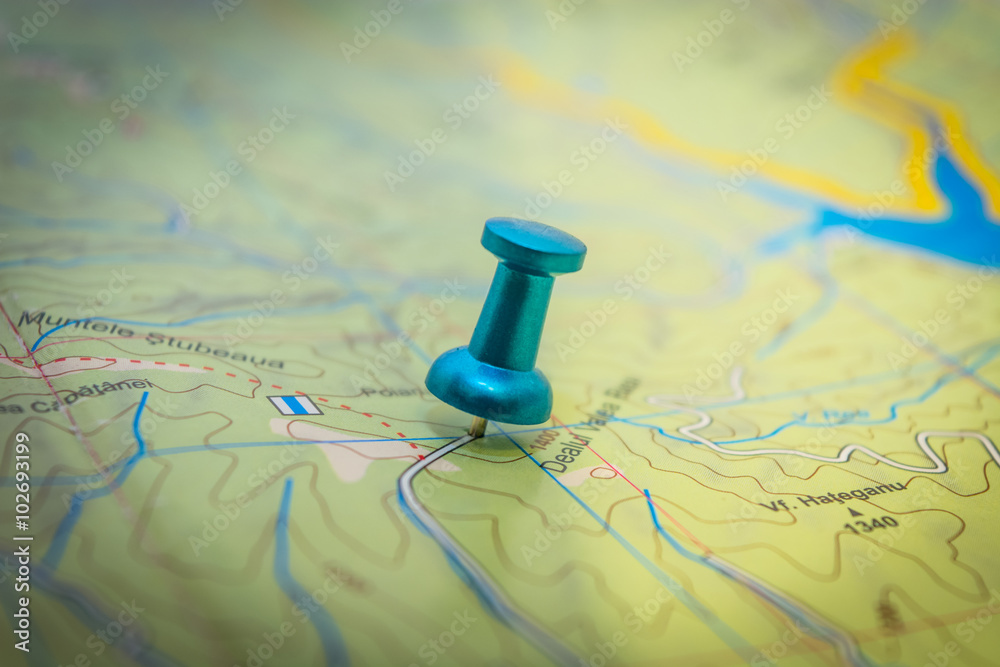 One blue pushpin embedded in the map One blue pushpin embedded in the map