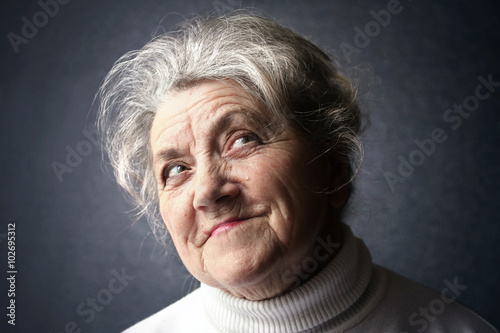 Happy old granny portrait on a dark background © Pavel Kubarkov