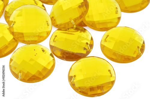 Yellow rhinestone on white background
