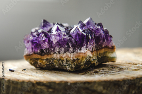 Raw amethyst rock with reflection on natural wood crystal  ametist