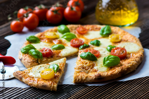 Homemade pizza with mozzarella, cherry tomatoes and Basil
