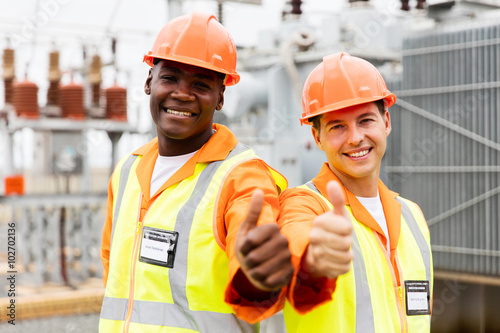 electricians giving thumb up in substation