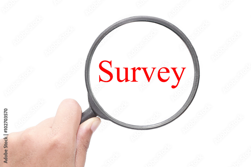 Hand showing Survey word through magnifying glass. Magnifying glass search concept. Isolated on white background. Hand showing Survey word through magnifying glass. Magnifying glass search concept. Isolated on white background.