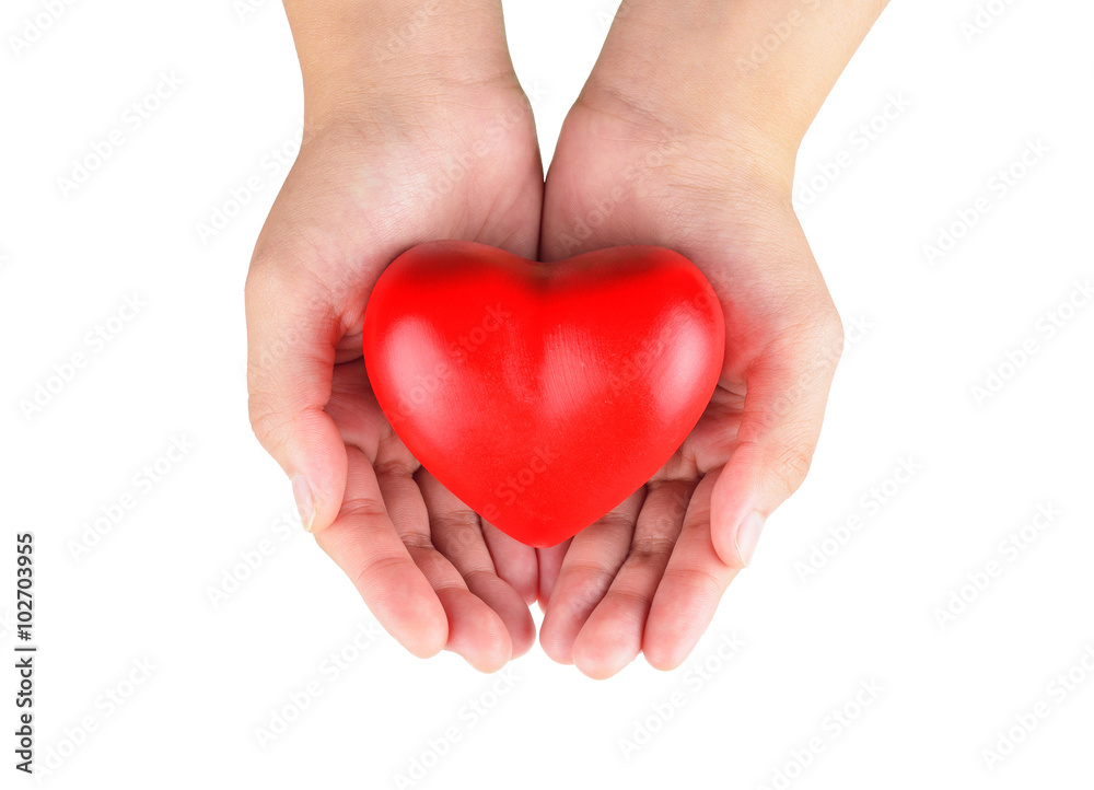 Hands holding a red heart as symbol for love and care