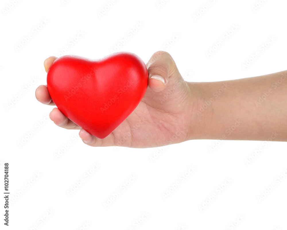Hands holding a red heart as symbol for love and care Hands holding a red heart as symbol for love and care