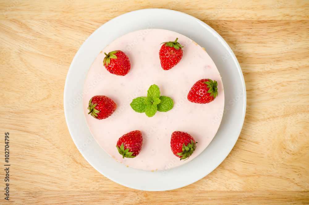 Homemade strawberry cheesecake on white plate Homemade strawberry cheesecake on white plate