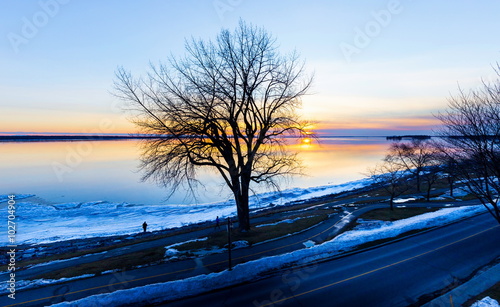 Lachine Lakeshore, January 2016. Sun setting in the horizon giving a false impression of a distant furnace that is warming the land. Temperatures touching -30 Celsius is all that can be expected.  photo