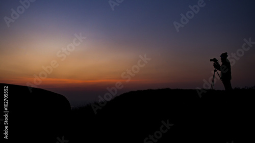 silhouette photographer on top of the mountain in the morning