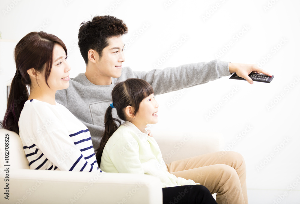 Happy Attractive Young Family watching the tv Happy Attractive Young Family watching the tv