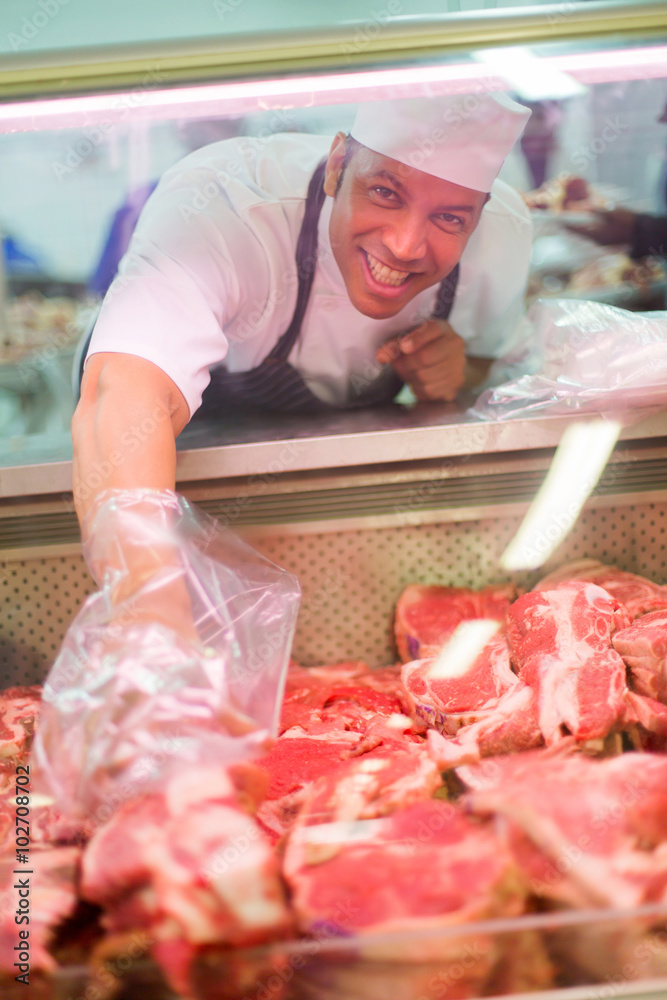 male butcher helping customer