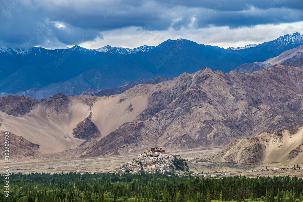 view of ancient Thiksey Monastery with the himalayan mountains - Leh, India.