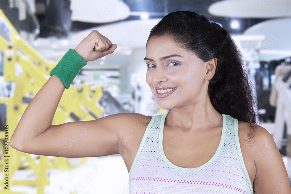 Healthy woman showing her arm muscle
