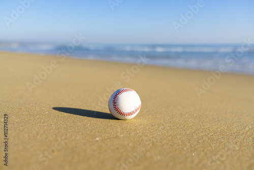 Baseball at a California beach with white wave in pacific ocean