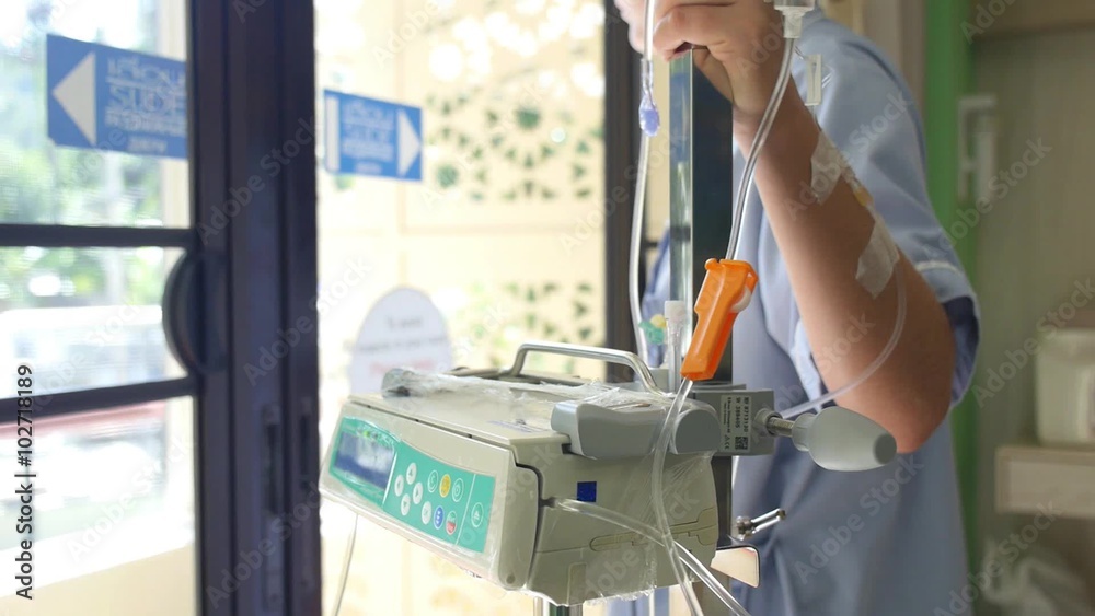 Woman Patient with IV Infusion Bottle in Hospital Woman Patient with IV Infusion Bottle in Hospital