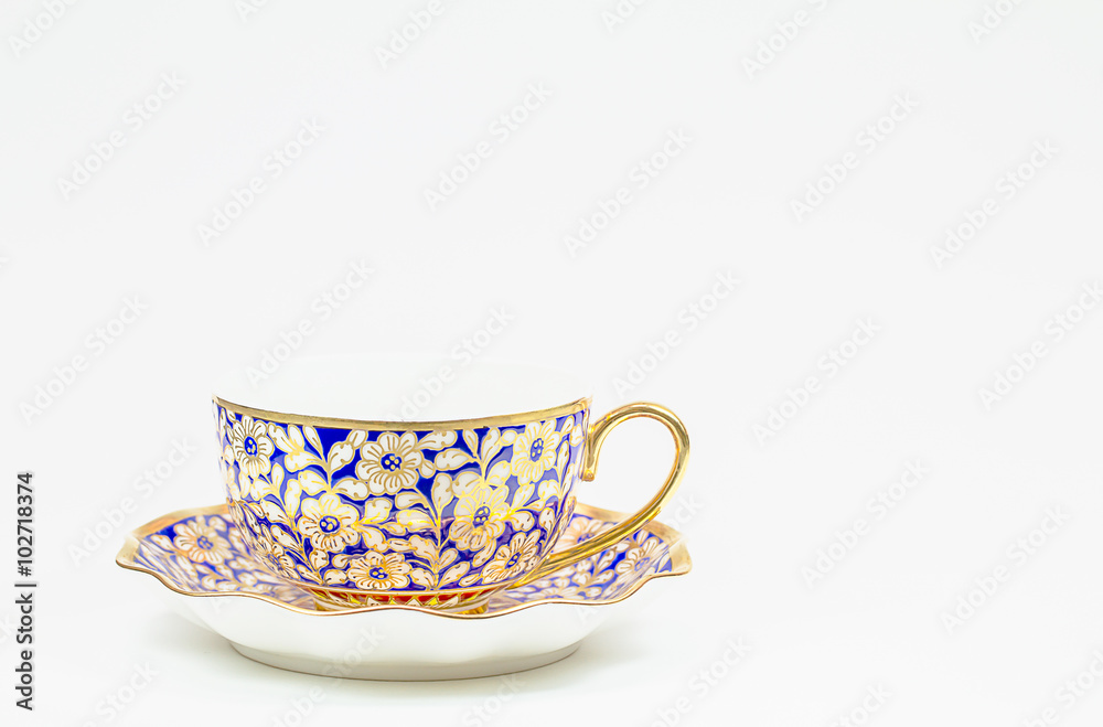 Antique Thai ceramic coffee cup with saucer on white background Antique Thai ceramic coffee cup with saucer on white background
