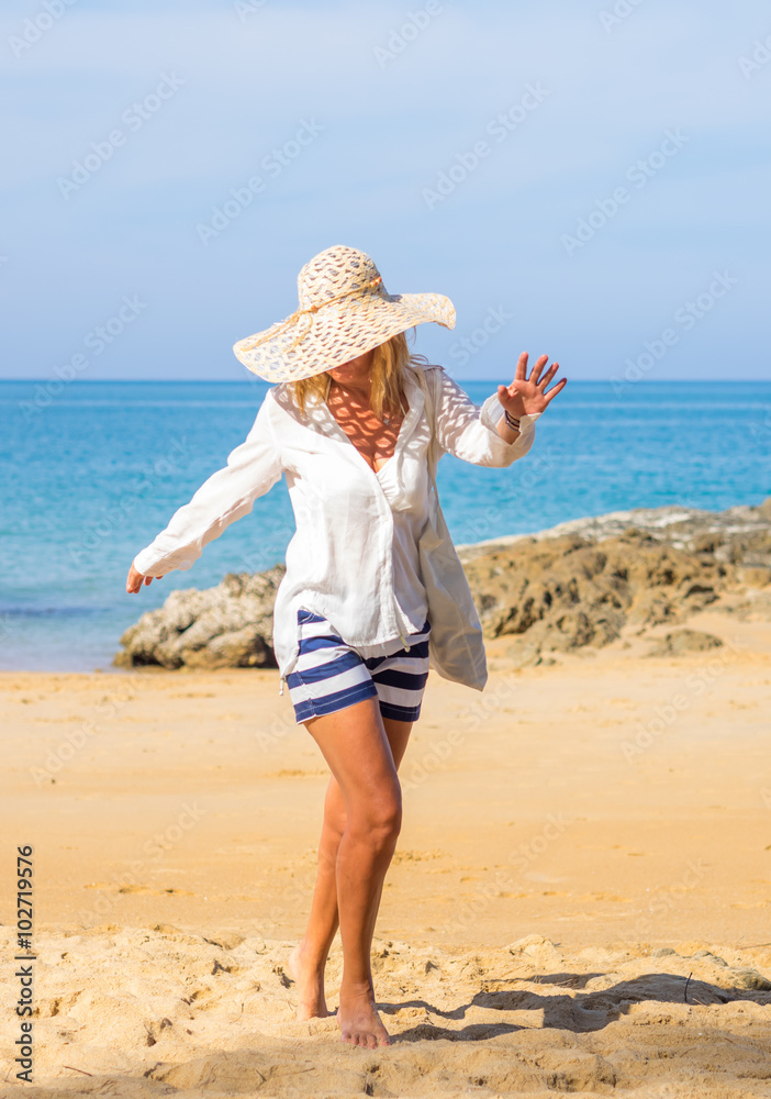 woman  enjoying perfect sunny day walking on the beach