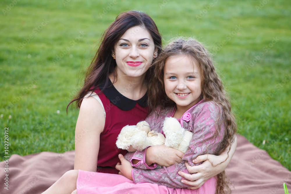 Mother hugs daughter in the park Mother hugs daughter in the park
