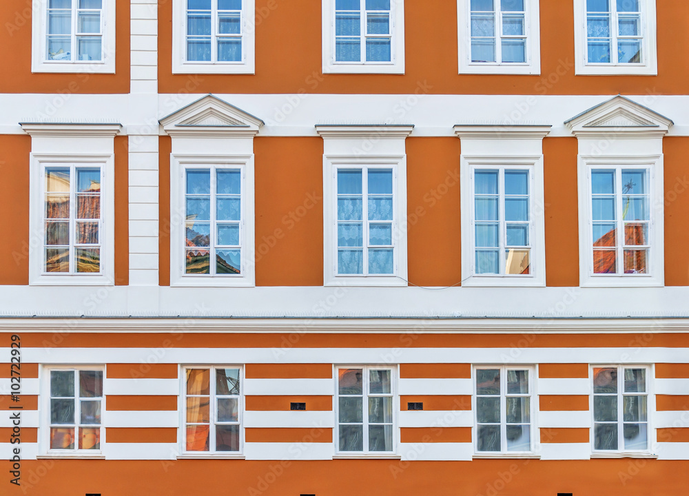 Urban orang building with blue window in the city