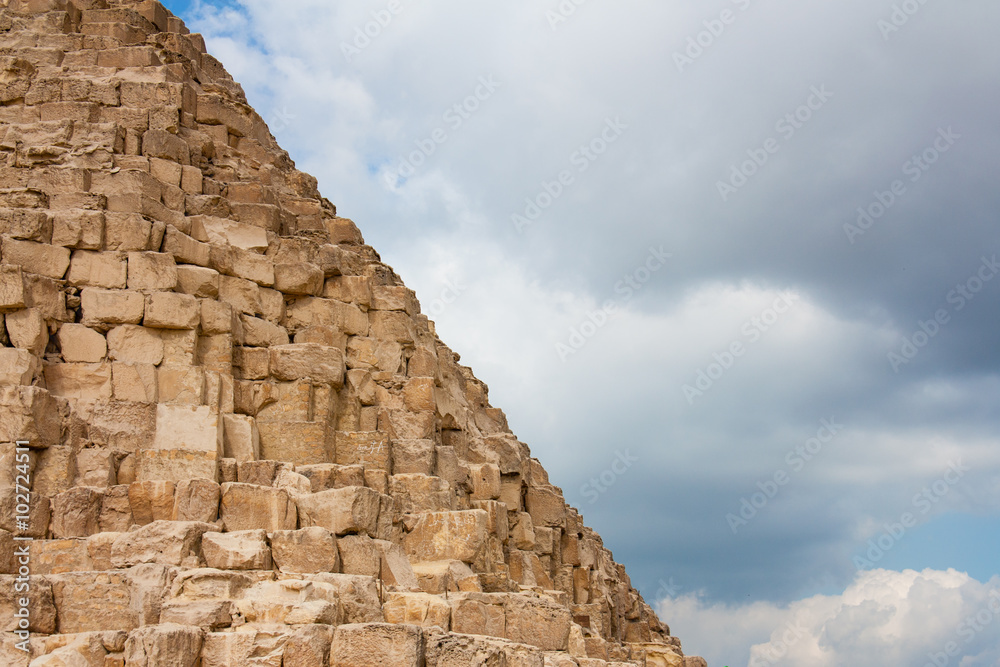 fragment of the great pyramids at Giza Plateau on the background of the sky 