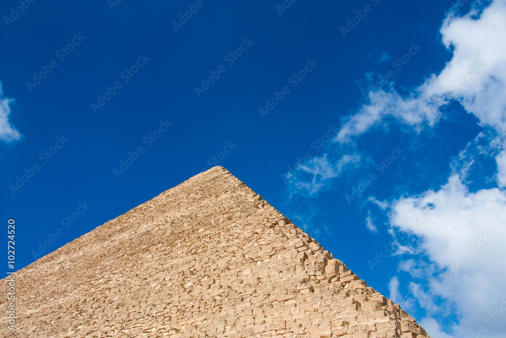 fragment of the great pyramids at Giza Plateau on the background of the sky 