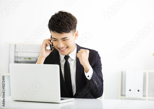 happy young businessman working in office