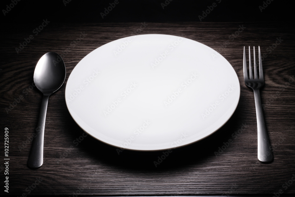 a set of cutlery on wooden background