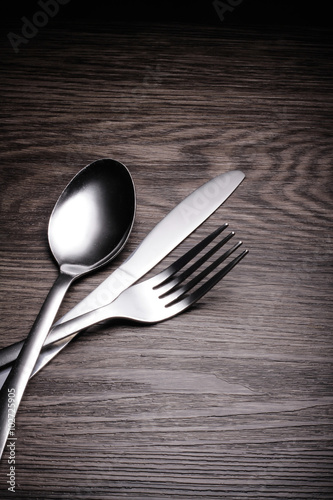 a set of cutlery on wooden background