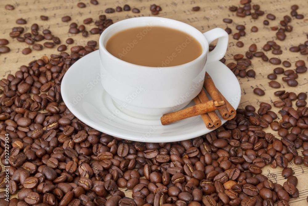 cup and coffee beans with cinnamon cup and coffee beans with cinnamon