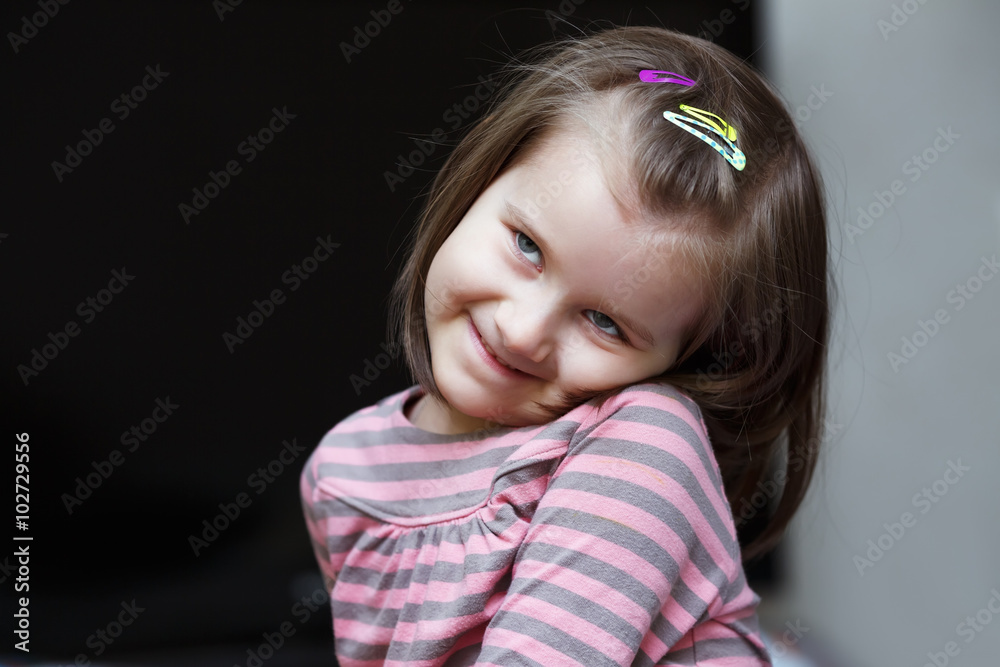Close-up portrait of happy smiling child girl against dark background. Close-up portrait of happy smiling child girl against dark background.