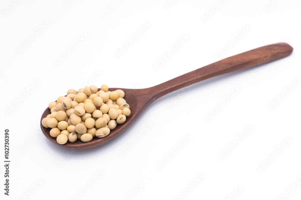 Soy beans in wooden spoon isolated on white background Soy beans in wooden spoon isolated on white background