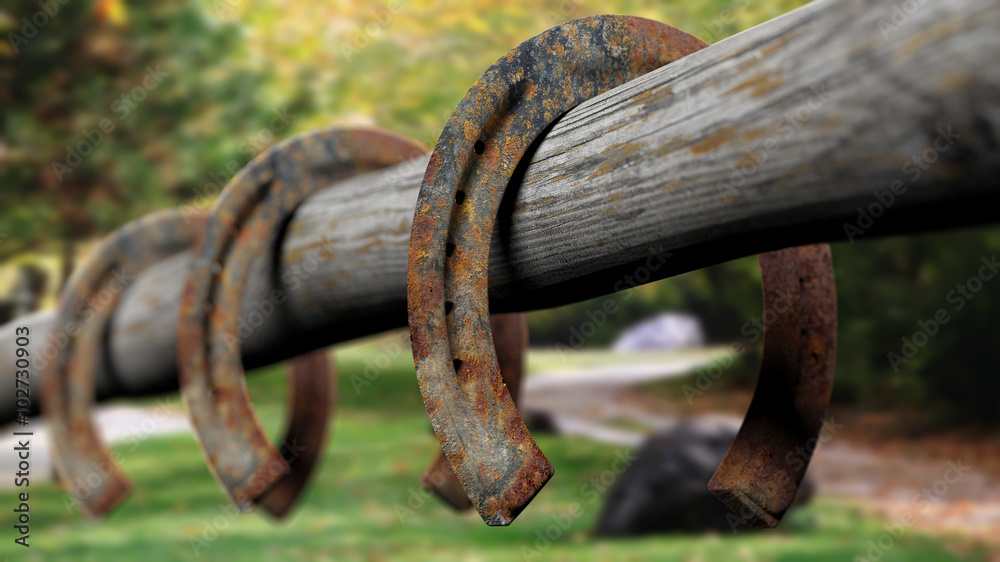 Old rusty horseshoes, set on wooden fence Old rusty horseshoes, set on wooden fence