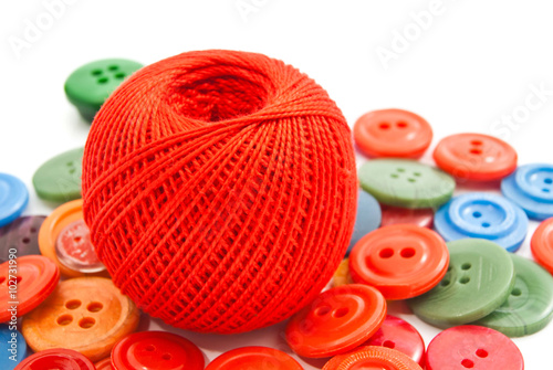 colored buttons and red ball of thread