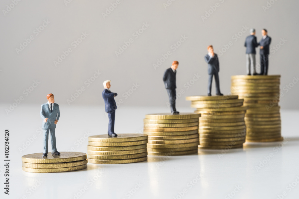 Businessmen standing on coins stack. Businessmen standing on coins stack.