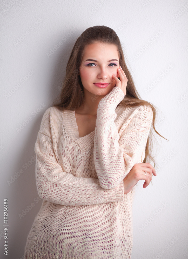 Young woman standing, isolated on gray background Young woman standing, isolated on gray background
