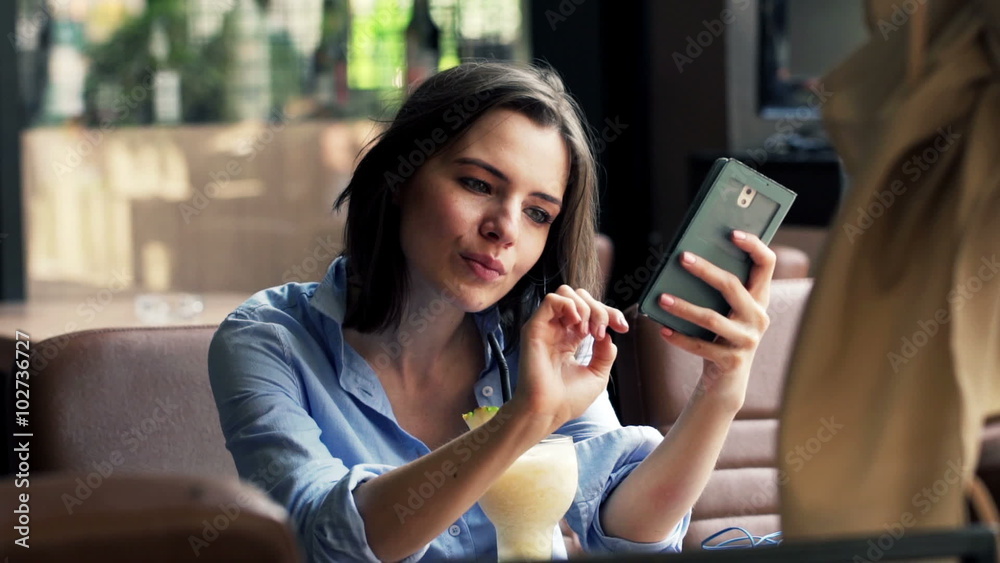Woman sitting with smartphone and drinking juice in cafe HD
Woman sitting with smartphone and drinking juice in cafe HD