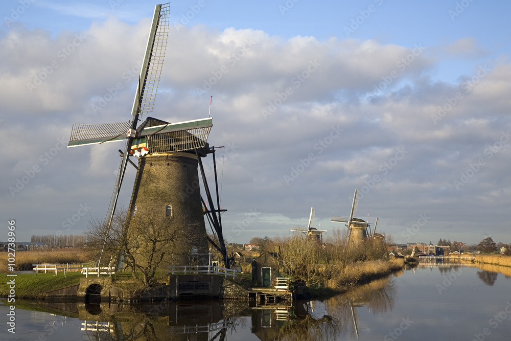 Row of Dutch windmills mirrored in water, Unesco World Heritage Kinderdijk, South Holland, Netherlands