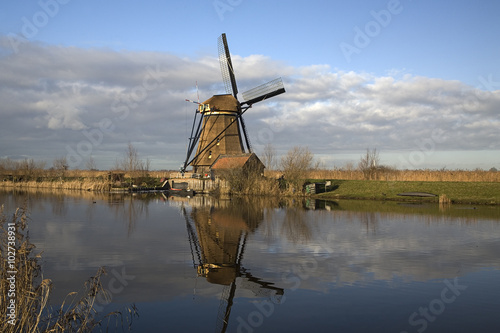 Row of Dutch windmills mirrored in water, Unesco World Heritage Kinderdijk, South Holland, Netherlands © roelmeijer
