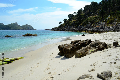 Corner of a beach of white sand and blue water on the island of Faro (Cies Islands, Spain)
