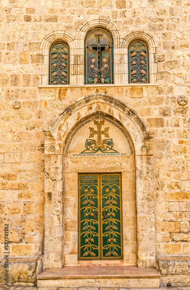 Church of the Holy Sepulchre detail green door and three windows, holiest Christian site in the world.